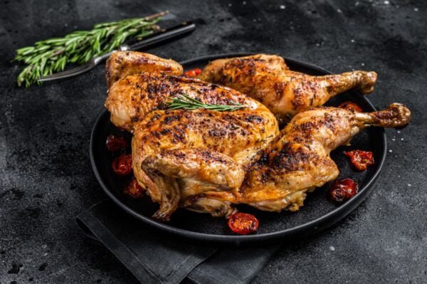 tobacco whole chicken on plate with herbs and toma 2022 09 06 23 53 48 utc Large