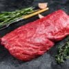 Raw fillet Tenderloin beef meat for steaks with thyme and rosemary. Black background. Top view